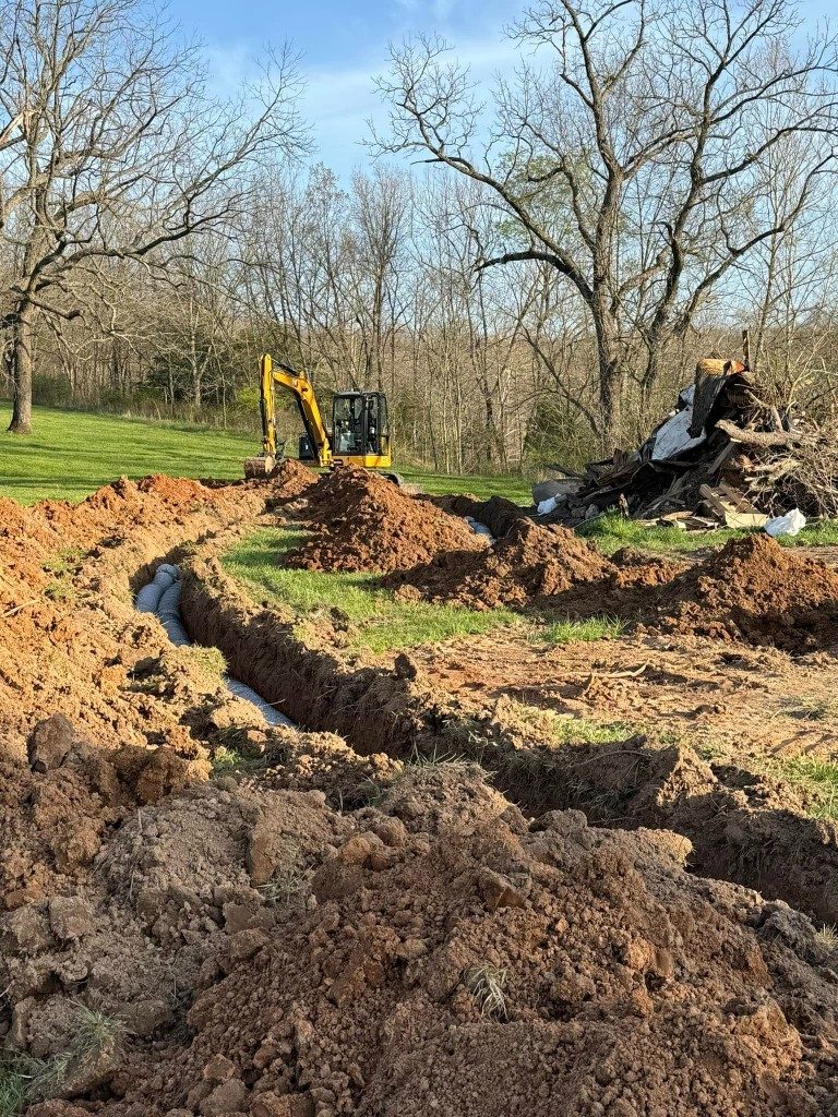 Excavator demolishing and clearing a site